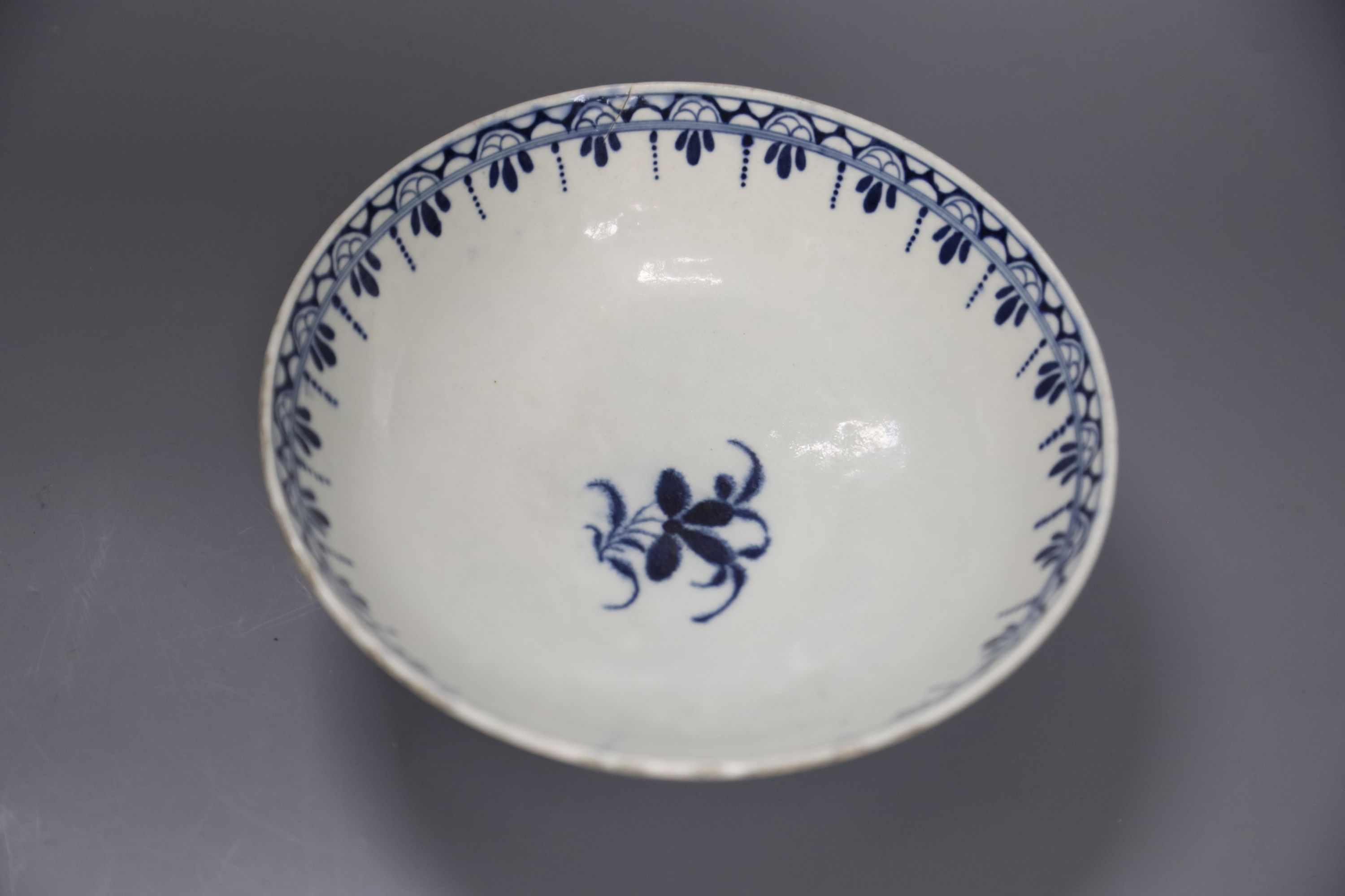 An 18th century Worcester bowl painted with the Peony pattern in blue, Workmans mark in blue to base, diameter 19cm